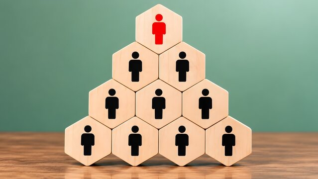 Pyramid of hexagonal blocks with a red leader figure at the top over a team, illustrating business hierarchy and management structure.