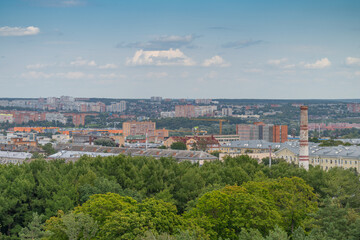 Fototapeta premium Stunning view of Tula's skyline revealing a blend of nature and urban life with distant buildings under a blue sky