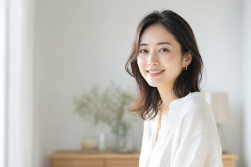 Fototapeta premium 明るい室内で微笑む日本人女性の自然なポートレート