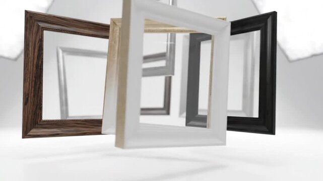 Various empty picture frames floating in a white studio space