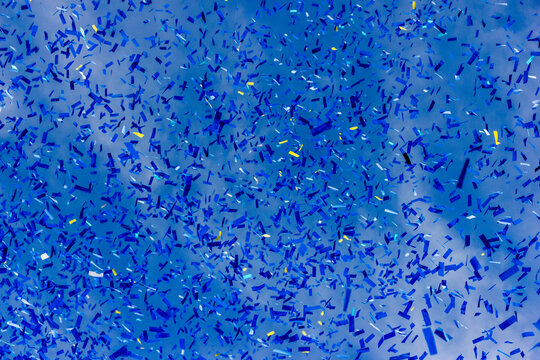 Blue Confetti Falling Over Sky Background Celebrating Party Event And Festive Atmosphere