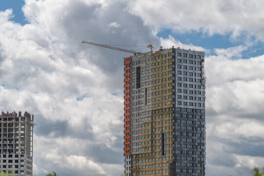 New high-rise building reaches for the sky under a dramatic cloudscape