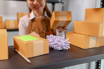 Warehouse employee cleaning storage shelves and organizing parcel boxes to maintain a tidy...