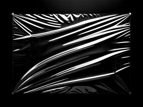 Crumpled Plastic Wrap Texture on Black Background.