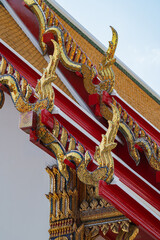Fototapeta premium Ornate Thai temple roof detail with golden Naga gable finials