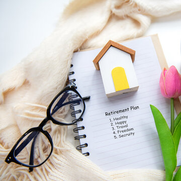 House model saving with tulip flower for financial wellness and retirement planning of seniors.  Financial Wellness for retirement Concept