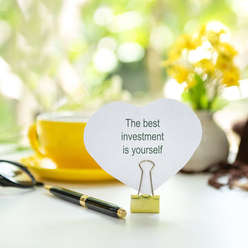 Notepad with the best investment is yourself. Inspirational workspace promoting self investment, personal growth and lifelong learning.  Goal Life and Investment Wellness Concept.
