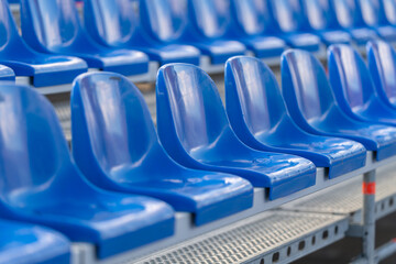 Fototapeta premium Vibrant blue stadium seats arranged in perfect lines inviting crowds for an exciting sporting event