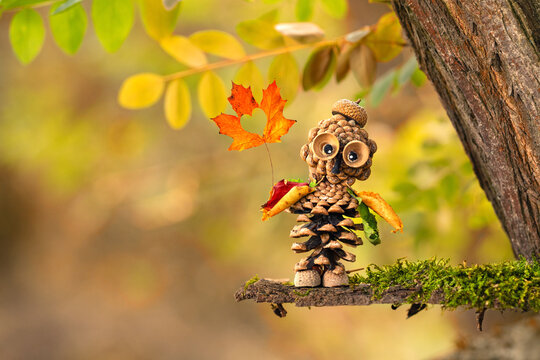 Handmade Autumn Craft Featuring Pinecones, Nuts, Acorns and Colorful Leaves