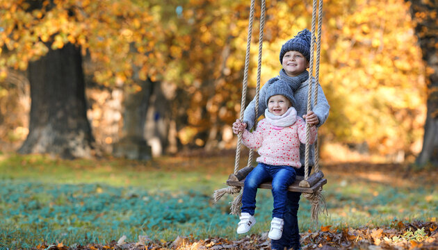 Boy and Girl Sharing a Peaceful Childhood Moment in the autumn park