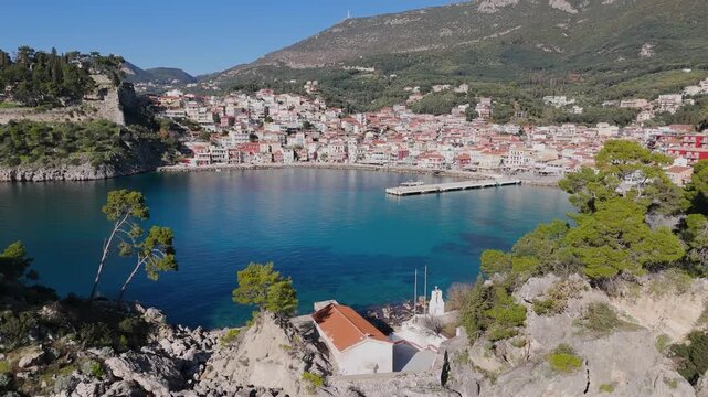 Aerial Pullback Revealing Rocky Islet and Parga Waterfront, Greece
