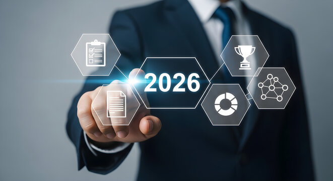 Businessman touching a futuristic virtual interface displaying business growth goals and strategic planning concepts for the year 2026