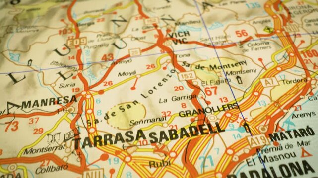 road network leading to barcelona, spain &ndash; gliding over atlas map