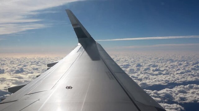 Looking out a cabin window at the engine and wing during a steady flight in the stratosphere.