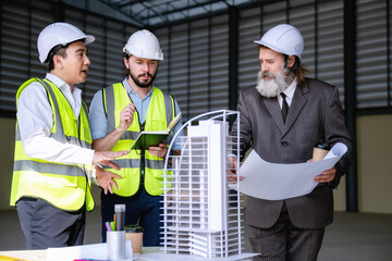 Construction manager team presented building structure process to senior management, using scale...