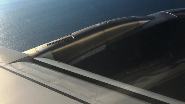Looking out a cabin window at engine vortex condensation in flight.