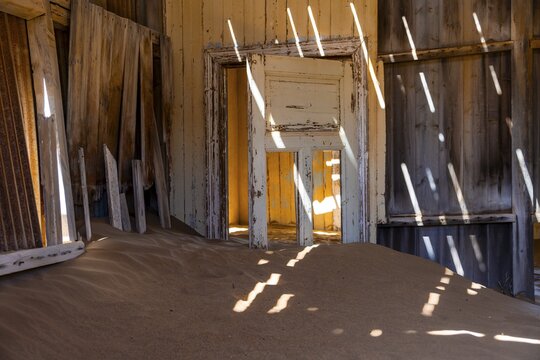 Interior view, door and house full of sand, former diamond mining town, Namib Desert, Kolmanskop, Karas, Namibia