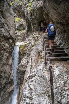 Hiker in a gorge, Hammersbach flows through H&ouml;llentalklamm, near Garmisch-Partenkirchen, Werdenfelser Land, Upper Bavaria, Bavaria, Germany