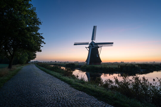 Windmill during a tranquil, late summer dawn in the Dutch countryside. Krimstermolen, Zuidwolde.