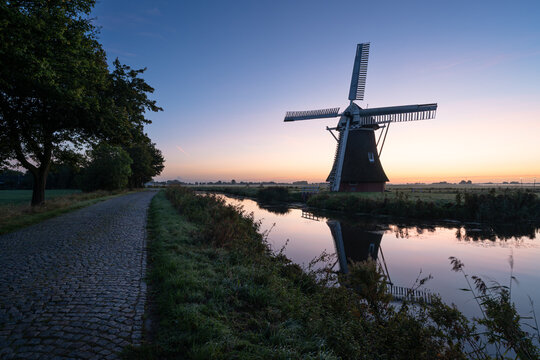 Windmill during a tranquil, late summer dawn in the Dutch countryside. Krimstermolen, Zuidwolde.