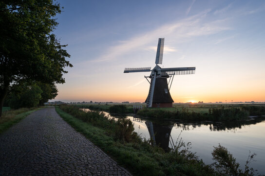 Windmill during a tranquil, late summer sunrise in the Dutch countryside. Krimstermolen, Zuidwolde