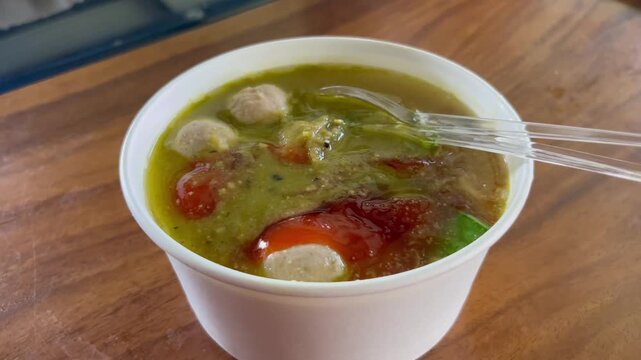 Traditional Indonesian meatball soup bakso served in white bowl