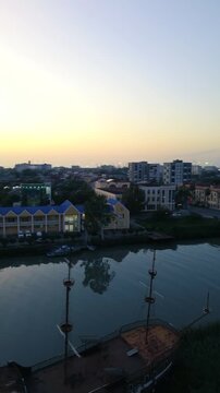 Aerial drone view of the central streets and urban architecture of Poti, Georgia, filmed vertically in 4K on September 15, 2024. The footage shows the city center, streets, buildings, and urban landsc