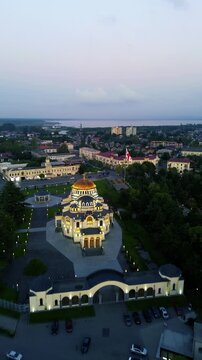 Aerial drone view of the central streets and urban architecture of Poti, Georgia, filmed vertically in 4K on September 15, 2024. The footage shows the city center, streets, buildings, and urban landsc