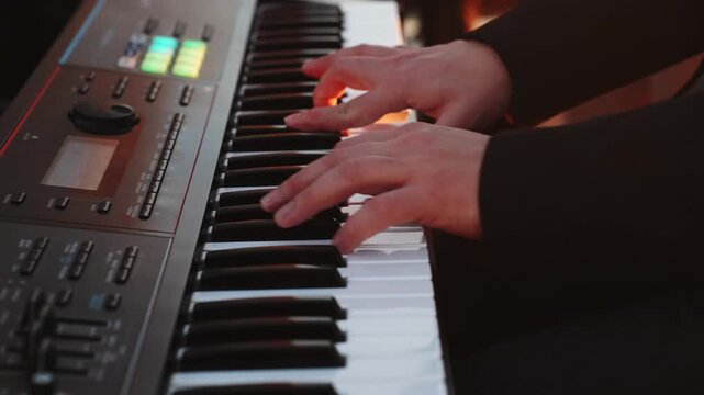 Musician hands playing synthesizer keyboard concert