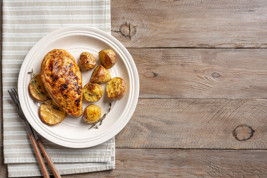 Oven roasted lemon garlic chicken and baby potatoes on plate