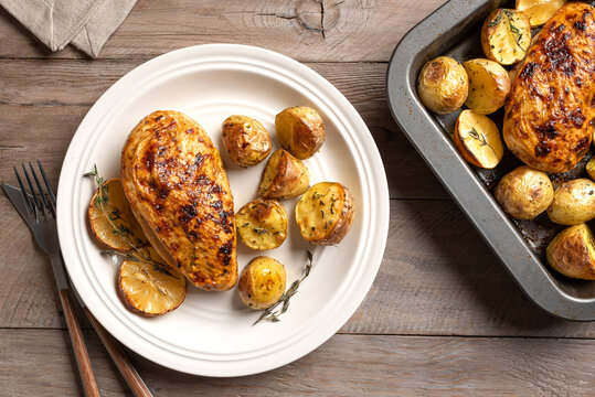 Oven roasted lemon garlic chicken and baby potatoes on plate