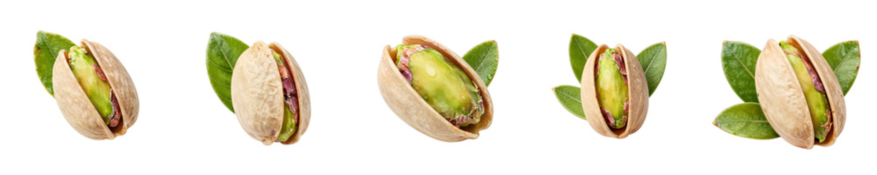 Five pistachios in nutshells are arranged with fresh green leaves on a black background