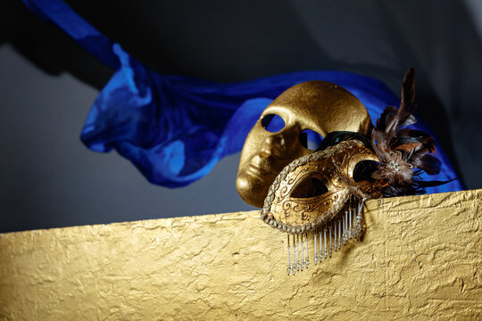 Golden carnival masks on a gold background.