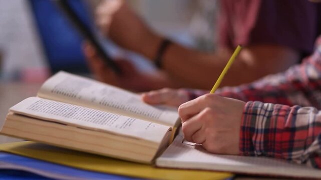 Close up man male boy hand writing holding pen notes notebook book student teacher library university education study thoughtful woman female girl learning prepare exam college course academy lecture
