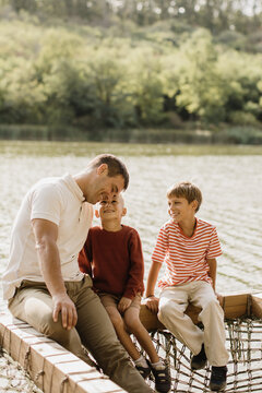 Joyful moments by the serene lake with family enjoying a sunny day