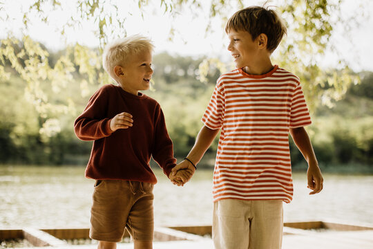 Joyful moments of friendship by the serene lakeside