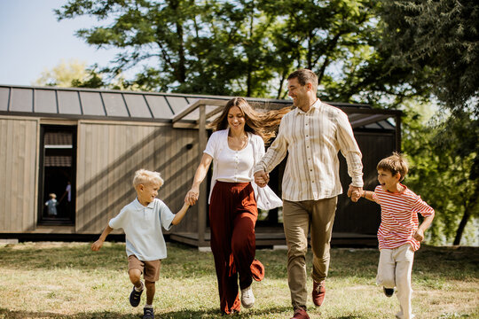 Family enjoys a sunny day running together in a park with laughter and joy