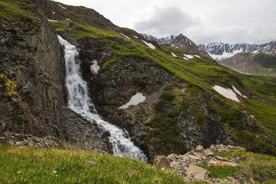 A view of the waterfall flowing down the steep cliff