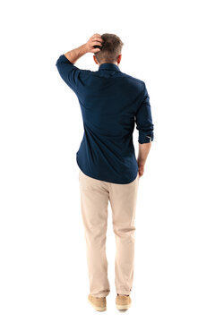 Back view of confused casual man scratching head