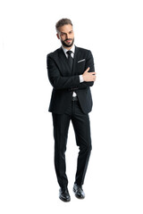 Elegant man in black suit standing with crossed arms