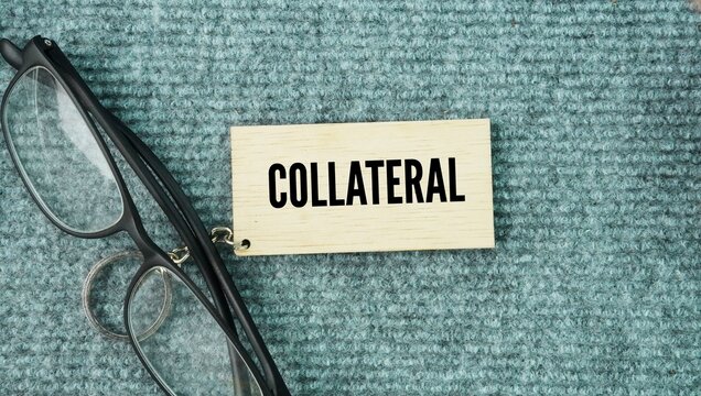 Glasses and a wooden tag with the word Collateral. valuable asset&mdash;such as a house, car, or cash&mdash;that a borrower pledges to a lender to guarantee the repayment of a loan
