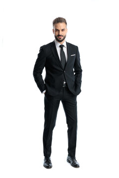Handsome man keeping hands in pockets and looking forward