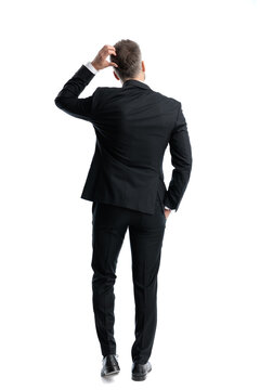 Rear view of stressed man scratching head