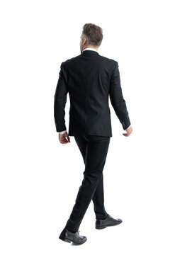 Back view of confident man walking away