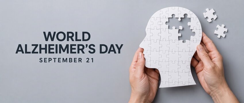 World Alzheimer's Day September 21 poster with hands holding white puzzle in shape of human head with missing pieces, memory loss and dementia awareness concept banner