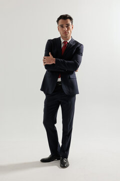 Stylish man standing with crossed arms