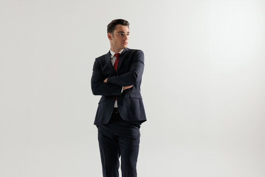 Serious man crossing arms and looking to the side