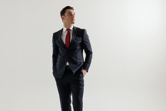 Handsome man with hands in pockets looking to the side