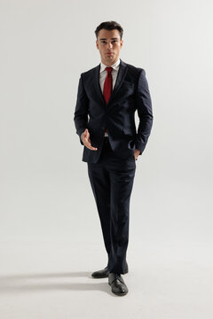 Confident man in suit walking forward and gesturing
