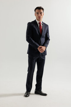 Professional man standing holding hands together